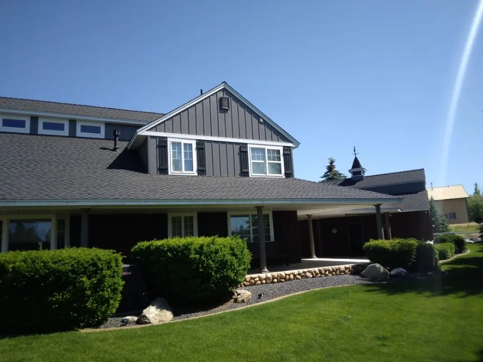 Stone home with a quality new roof installed by DG Contracting in Spokane