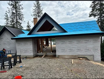 Synthetic underlayment installed ahead of metal roofing panels by DG Contracting